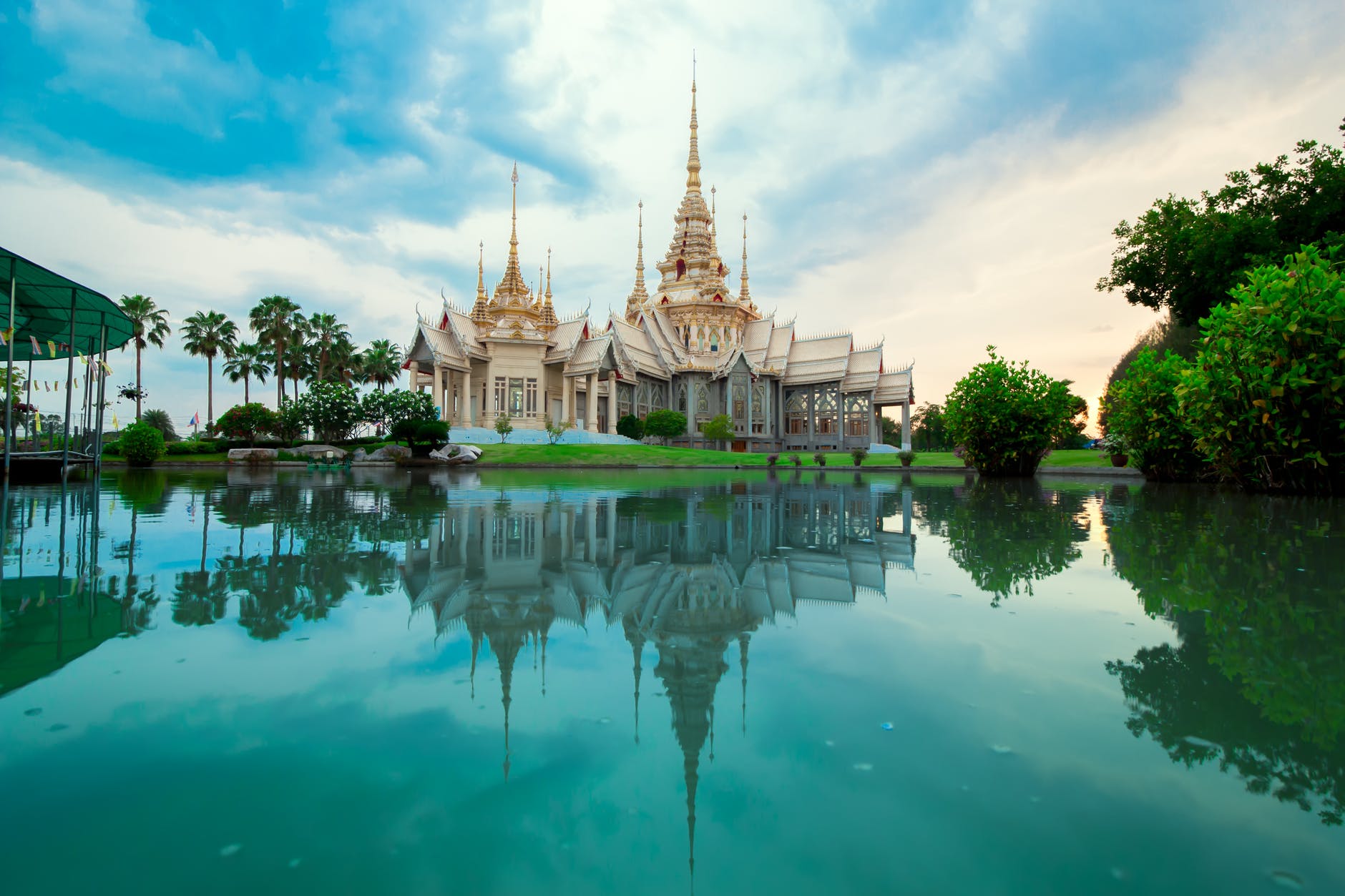 beige temple reflecting on body of water
